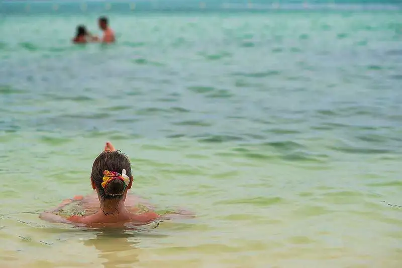 Swimming in shallow clear water off a beach