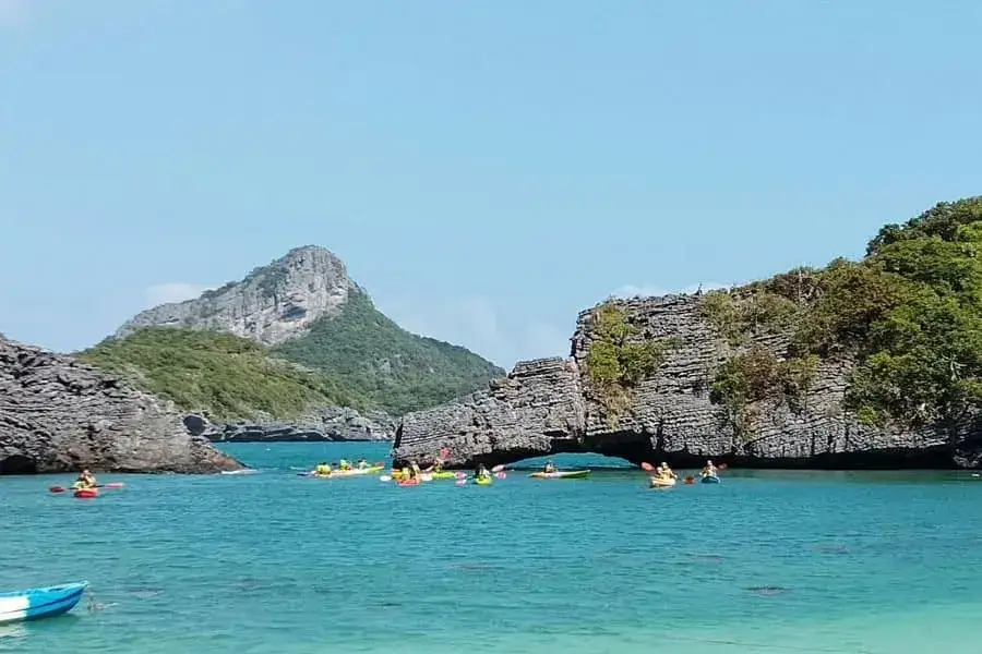 Kayaks below the rock arch of Koh Sam Sao